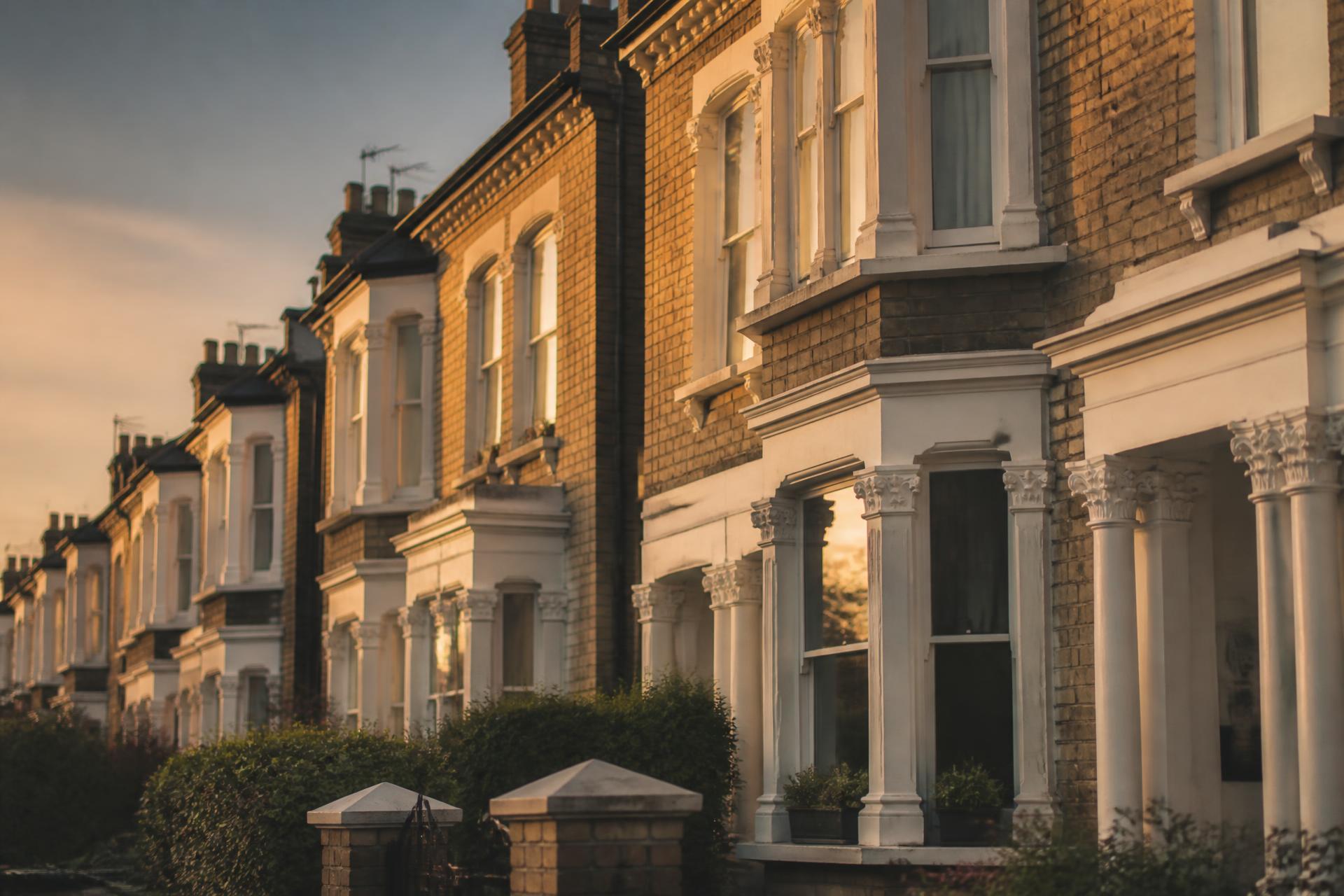 A row of period brick terraced houses at golden hour